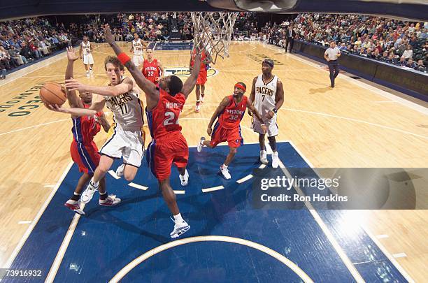 Mike Dunleavy of the Indiana Pacers lays the ball up against Antonio McDyess of the Detroit Pistons during the game at Conseco Fieldhouse on April 3,...