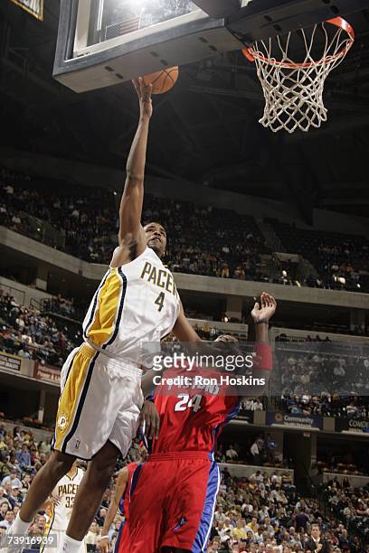 Shawne Williams of the Indiana Pacers goes to the basket over Antonio McDyess of the Detroit Pistons during the game at Conseco Fieldhouse on April...