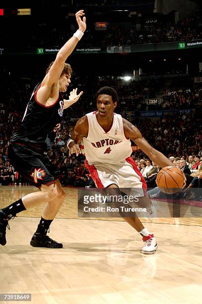 Chris Bosh of the Toronto Raptors drives around Louis Amundson of the Philadelphia 76ers on April 18, 2007 at the Air Canada Centre in Toronto,...