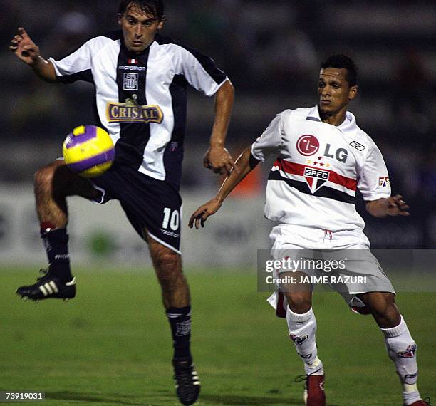 Brazil's Sao Paulo Futbol Club Souza vies for the ball with Peru's Alianza Lima midfielder Martin Liguera during their Libertadores Cup soccer match...