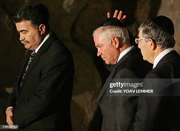 Defense Secretary Robert Gates walks alongside his Israeli counterpart Amir Peretz as he fixes his Kippa or Jewish head cover 19 April 2007 during a...