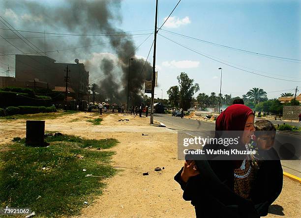 Iraqis evacuate the site of a suicide car bomb explosion in the Jadriya neighborhood on April 19, 2007 in Baghdad, Iraq. A suicide car bomber rammed...