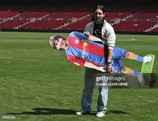 Barcelona's Argentinian Leo Messi poses with his portrait at Camp Nou stadium, 19 April 2007, in Barcelona. Messi scored yesterday against Getafe a...