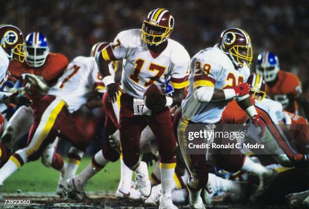 Doug Wiliams of the Washington Redskins handing off during Super Bowl XXII against the Denver Broncos on January 31, 1988 in San Diego, California.