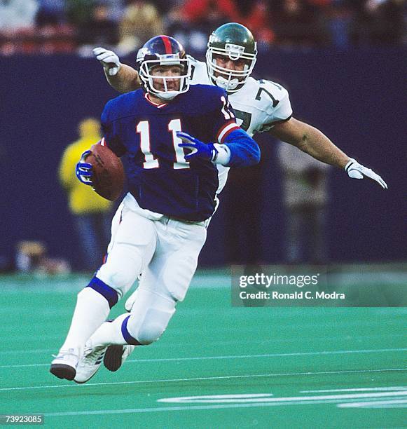 Phil Sims of the New York Giants scrambles during a game against the New York Jets on December 18, 1988 in East Rutherford, New Jersey.