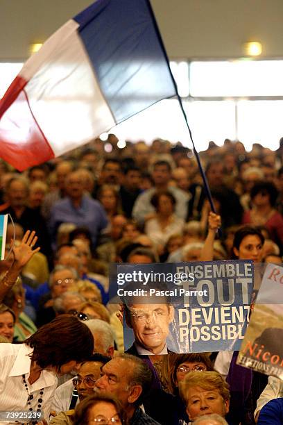 Supporters attend the last campaign meeting of Nicolas Sarkozy, head of the right-of-centre French conservative party UMP and candidate for the...