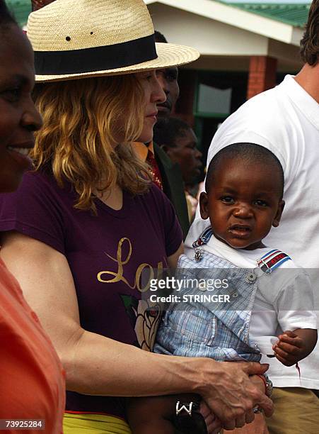 Madonna the "Queen of Pop", poses with her Malawian son David Banda in Mphandula 19 April 2007 Madonna urged Malawian youths to work hard to realise...