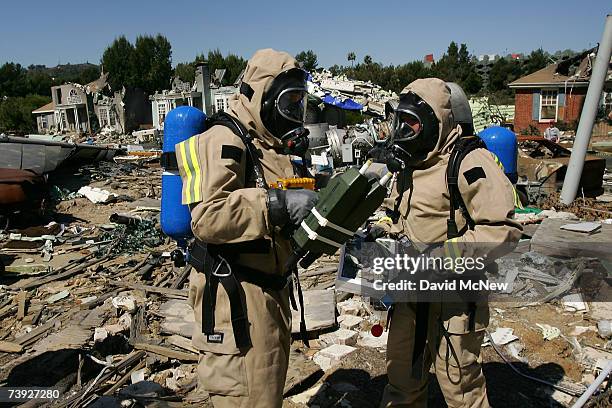 Members of the US Army 9th Civil Support Team evaluate hazards as the first responders in the crash zone during an exercise simulating mass...