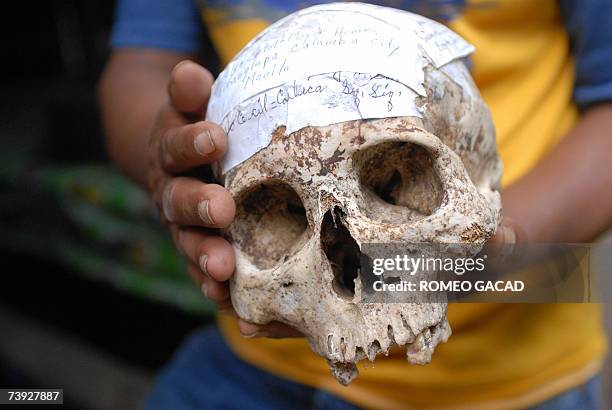Siquijor, PHILIPPINES: TO GO WITH STORY: PHILIPPINES-MAGIC-WITCHCRAFT-SORCERER by Karl Wilson Filipino sorcerer Alberto 'Edol' Baroro holds a human...