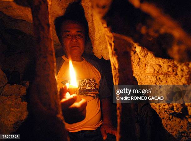 Siquijor, PHILIPPINES: TO GO WITH STORY: PHILIPPINES-MAGIC-WITCHCRAFT-SORCERER by Karl Wilson Filipino sorcerer Alberto 'Edol' Baroro holds a candle...