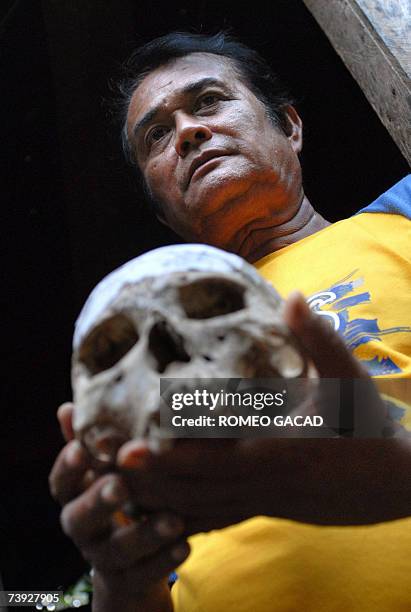 Siquijor, PHILIPPINES: TO GO WITH STORY: PHILIPPINES-MAGIC-WITCHCRAFT-SORCERER by Karl Wilson Filipino sorcerer Alberto 'Edol' Baroro holds a human...