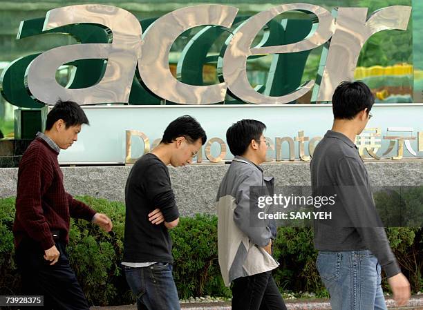 People walk past a logo of Acer in Shichih, Taipei county, 20 April 2007. Preliminary figures from a research house showed 20 April 2007 personal...