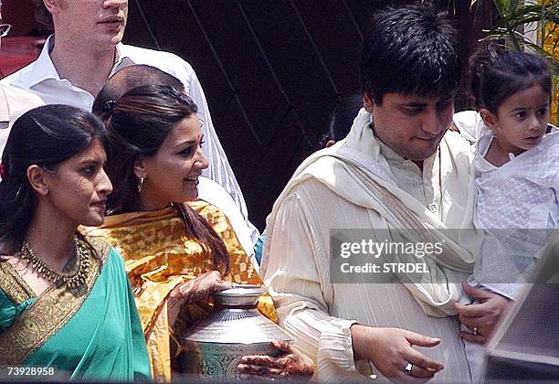 Guests and friends of the Bachchan family including Sonali Bendre and husband Goldie Behl carry the kalash -- ceremonial urn -- as part of a...