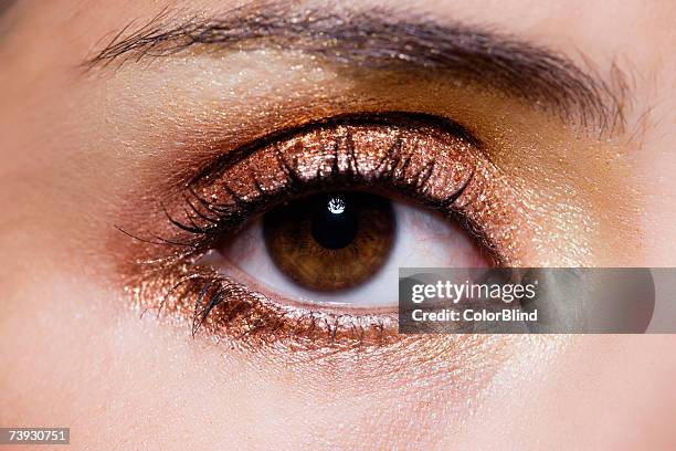 close up of woman's eye with gold eye make-up - eye make up ストックフォトと画像