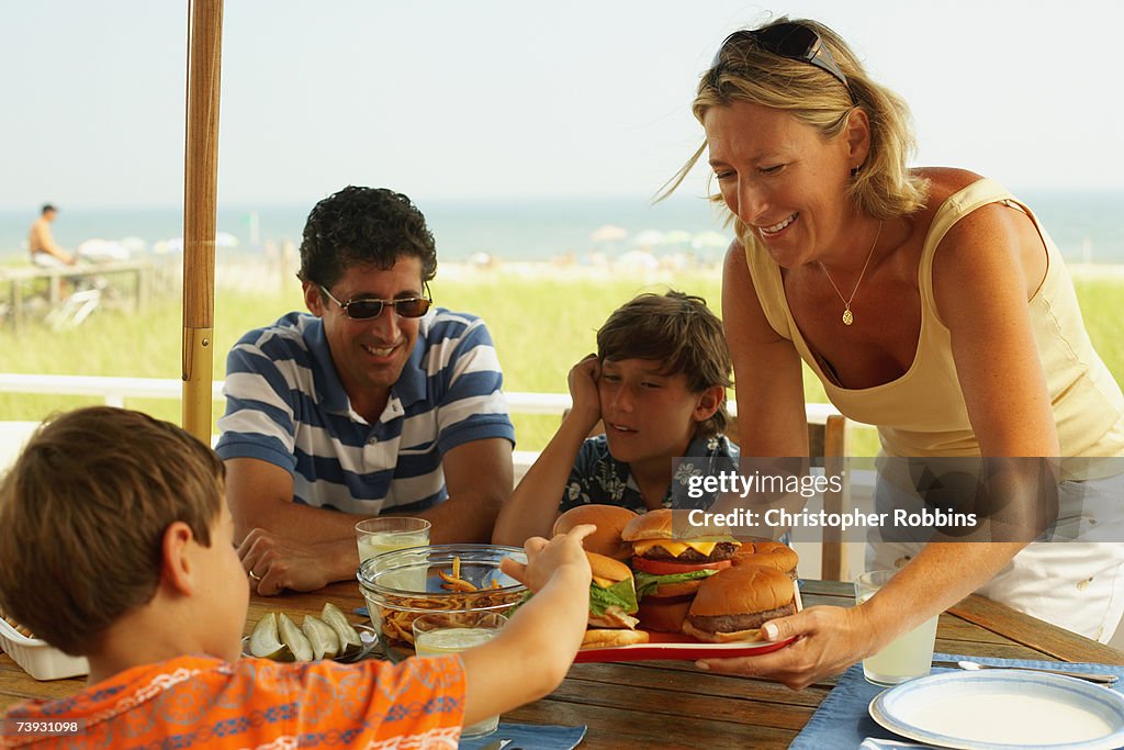 Family with children (8-11) having picnic with hamburgers