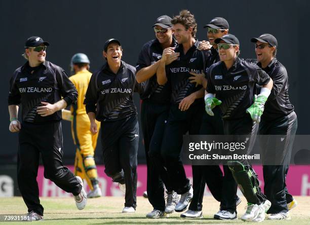 James Franklin of Nrew Zealand is congratulated by team-mates after taking the wicket of Adam Gilchrist of Australia during the ICC Cricket World Cup...