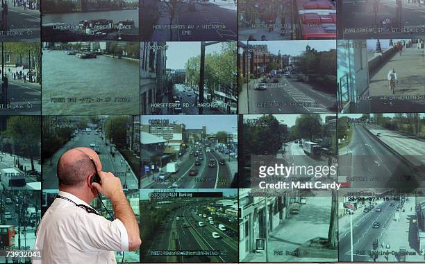 Police officer watches a bank television monitors showing a fraction of London's CCTV camera network in the Metropolitan Police's new Special...