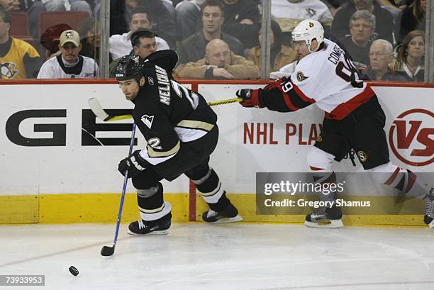 Josef Melichar of the Pittsburgh Penguins skates with the puck as Mike Comrie of the Ottawa Senators pressures him in game 4 of the Eastern...