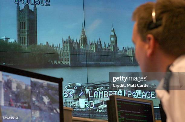Police officer watches banks of television monitors showing a fraction of London's CCTV camera network in the Metropolitan Police's new Special...