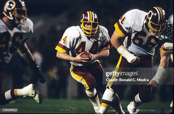 John Riggins of the Washington Redskins carries the ball during Super Bowl XVIII against the Oakland Raiders on January 22, 1984 in Tampa, Florida.