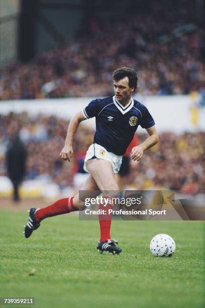 Scottish professional footballer Davie Cooper pictured in action playing for the Scotland national football team during an international game circa...