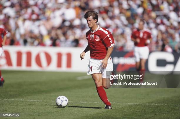 Danish footballer and forward with the Denmark national football team, Brian Laudrup pictured with the ball during a Denmark game at the 1998 FIFA...
