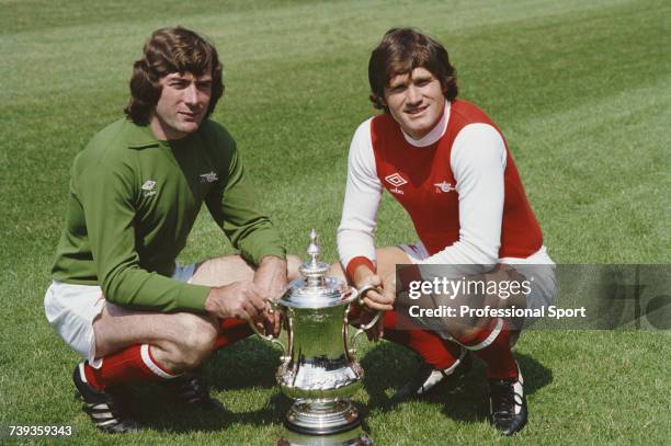 Northern Irish footballers, goalkeeper and captain with Arsenal respectively, Pat Jennings and Pat Rice pictured posing with the FA Cup trophy on the...