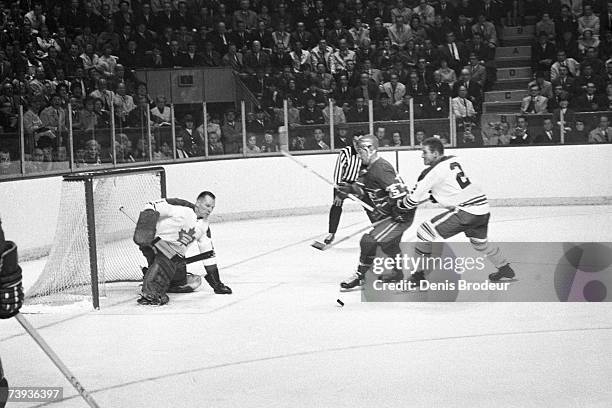 S: Goaltender Johnny Bower of the Toronto Maple Leafs defends the net against the Montreal Canadiens.