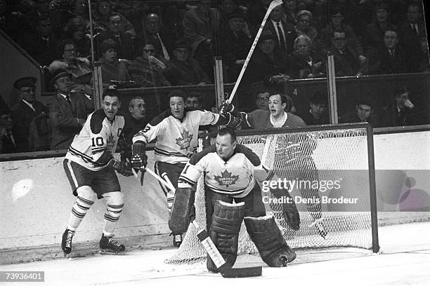 S: Goaltender Johnny Bower of the Toronto Maple Leafs defends the net against the Montreal Canadiens.