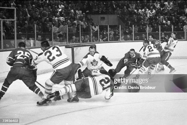 S: Goaltender Johnny Bower of the Toronto Maple Leafs defends the net against the Montreal Canadiens.