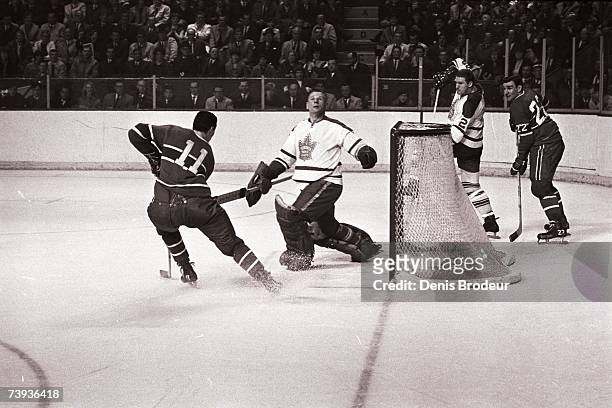 S: Goaltender Johnny Bower of the Toronto Maple Leafs defends the net against the Montreal Canadiens.