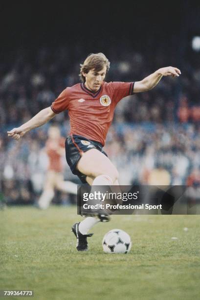 Scottish professional footballer Kenny Dalglish pictured in action playing for the Scotland national football team in the home international British...