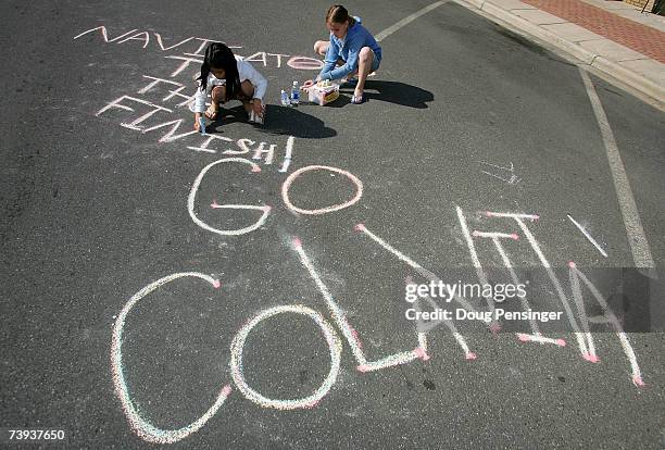 Kim Jade left and Staphanie Babb of Dalton write well wishes for the team on the street at the start of Stage Five of the Tour de Georgia on April...