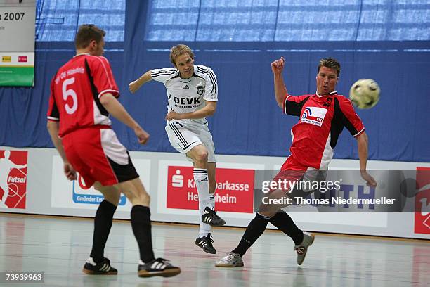 Malte Limbrock of Muenster in action with Roberto Cid-Valdez and Bjoern Zimmermann of Hildesheim during the Futsal Cup match between UFC Muenster and...