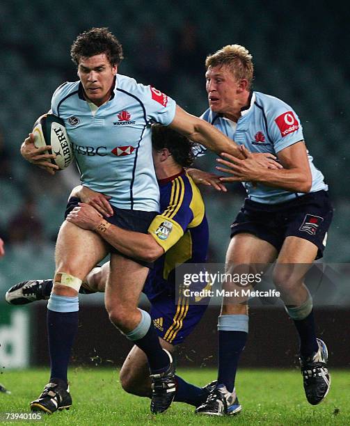 Ben Jacobs of the Waratahs is tackled during the round 12 Super 14 match between the Waratahs and the Highlanders at Aussie Stadium on April 21, 2007...
