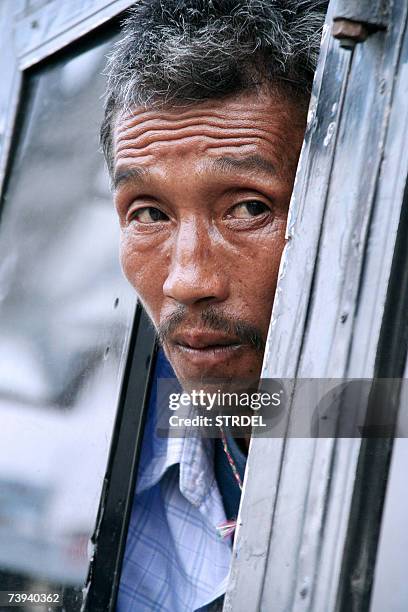 Bhutanese refugee, Sitaram waits in a bus after a protest rally organized by the National Front for Democracy, Bhutan at Mechi River Bridge on the...