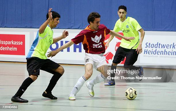 Daniel Marjanovic of Krefeld in action with Mehdi Aghayarzadeh and Mohammad Saedi-Madani of Vilbel during the Futsal Cup match betweenFC Bad Vilbel...