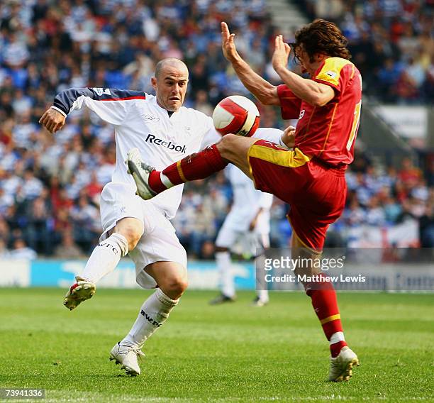 David Thompson of Bolton and Stephen Hunt of Reading challenge for the ball during the Barclays Premiership match between Bolton Wanderers and...