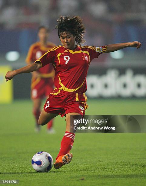 Han Duan of China shoots during an exhibition match against the FIFA Women's World Stars Team at the Wuhan Sport Center Stadium on April 21, 2007 in...