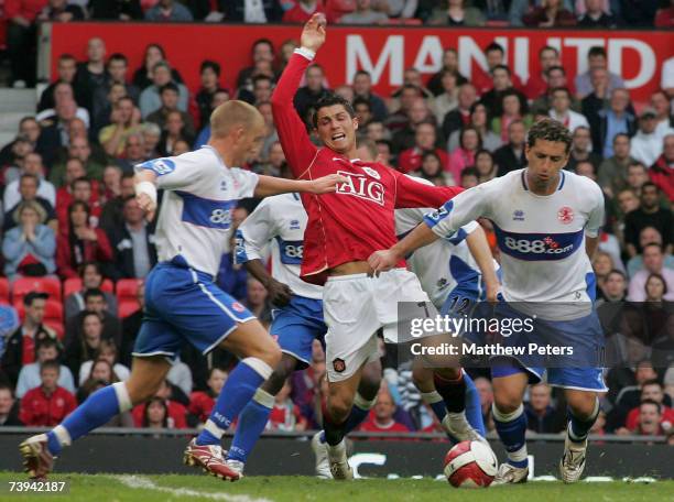 Cristiano Ronaldo of Manchester United clashes with Emanuel Pogatetz and Fabio Rochemback of Middlesbrough during the Barclays Premiership match...