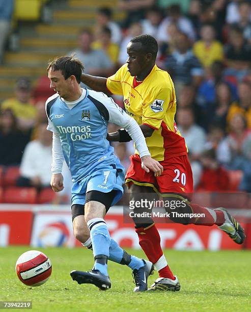 Al Bangura of Watford tangles with Stephen Ireland of Manchester City during the Barclays Premiership match between Watford and Manchester City at...