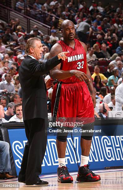 Head coach Pat Riley of the Miami Heat talks with Shaquille O'Neal against the Chicago Bulls in Game One of the Eastern Conference Quarterfinals...