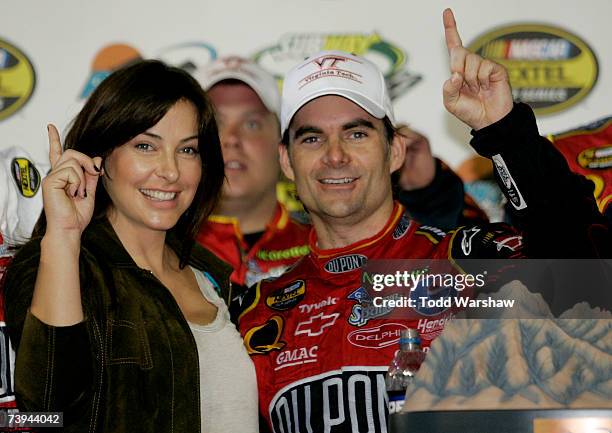Jeff Gordon, driver of the DuPont Chevrolet, celebrates in victory lane with his wife, Ingrid Vandebosch, after winning the NASCAR Nextel Cup Series...