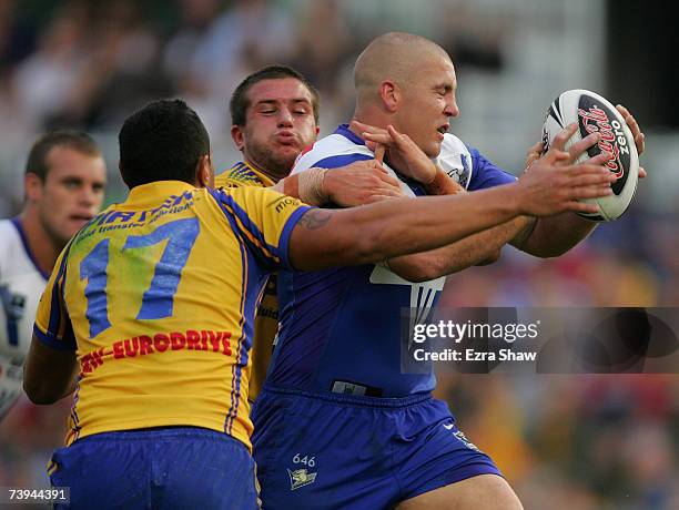 Mark O'Meley of the Bulldogs is tackled by Josh Cordoba and Feleti Mateo of the Eels during the round six NRL match between the Parramatta Eels and...