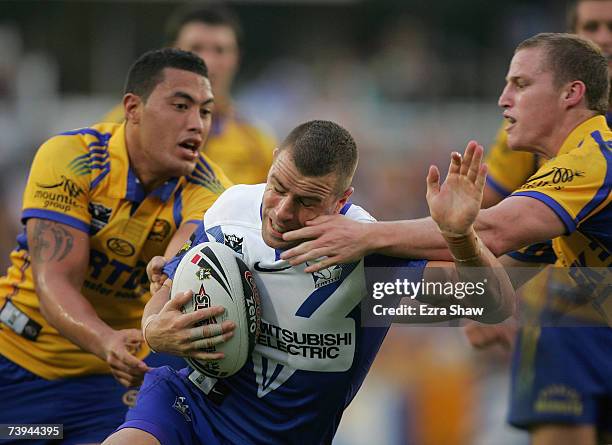 Luke Patten of the Bulldogs is tackled by Feleti Mateo and Brett Finch of the Eels during the round six NRL match between the Parramatta Eels and the...