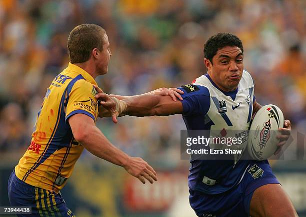 Willie Tonga of the Bulldogs tries to keep away from Brett Finch of the Eels during the round six NRL match between the Parramatta Eels and the...