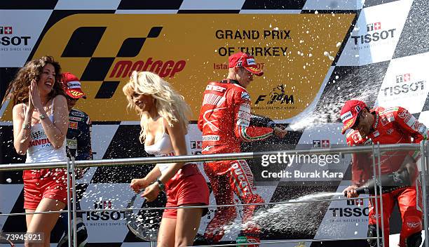Australian rider Casey Stoner of Ducati Marlboro Team celebrates his win with second place rider Toni Elias of Honda Gresini Team and third place...