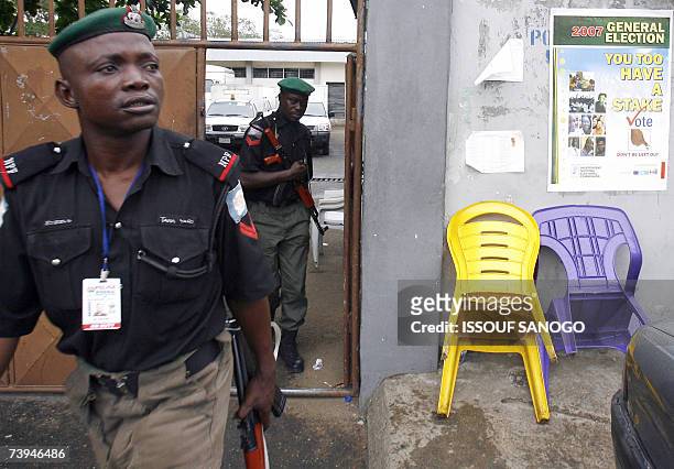 Nigerian policemen leave the Independent Electoral Commission headquarters 22 April 2007 in Lagos where forces were deployed on the eve of the...