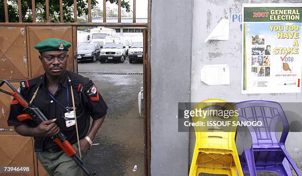 Nigerian policeman leaves the Independent Electoral Commission headquarters 22 April 2007 in Lagos where forces were deployed on the eve of the...