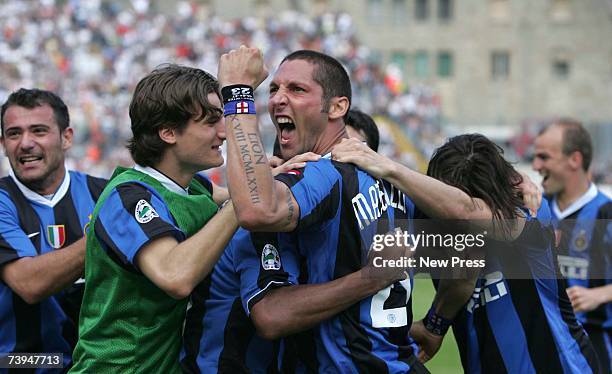 Goal scorer Marco Materazzi raises a jubilant fist as he celebrates with his teammates Inter Milan's victory of the match and the championship title...